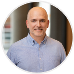 Headshot of Nick Gavronsky, Co-Founder & CEO, smiling in a white shirt.