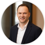 Black-and-white headshot of Alex Calaf, VP of Plan Administration.